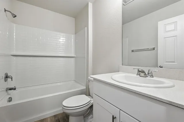 a bathroom with a sink a toilet and a bathtub