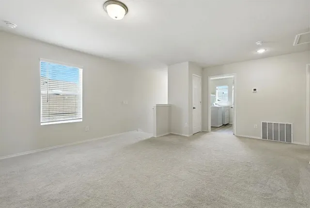 an empty room with windows and closet