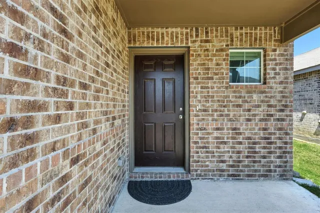 a view of a door and brick wall