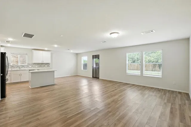 a view of kitchen with wooden floor and windows