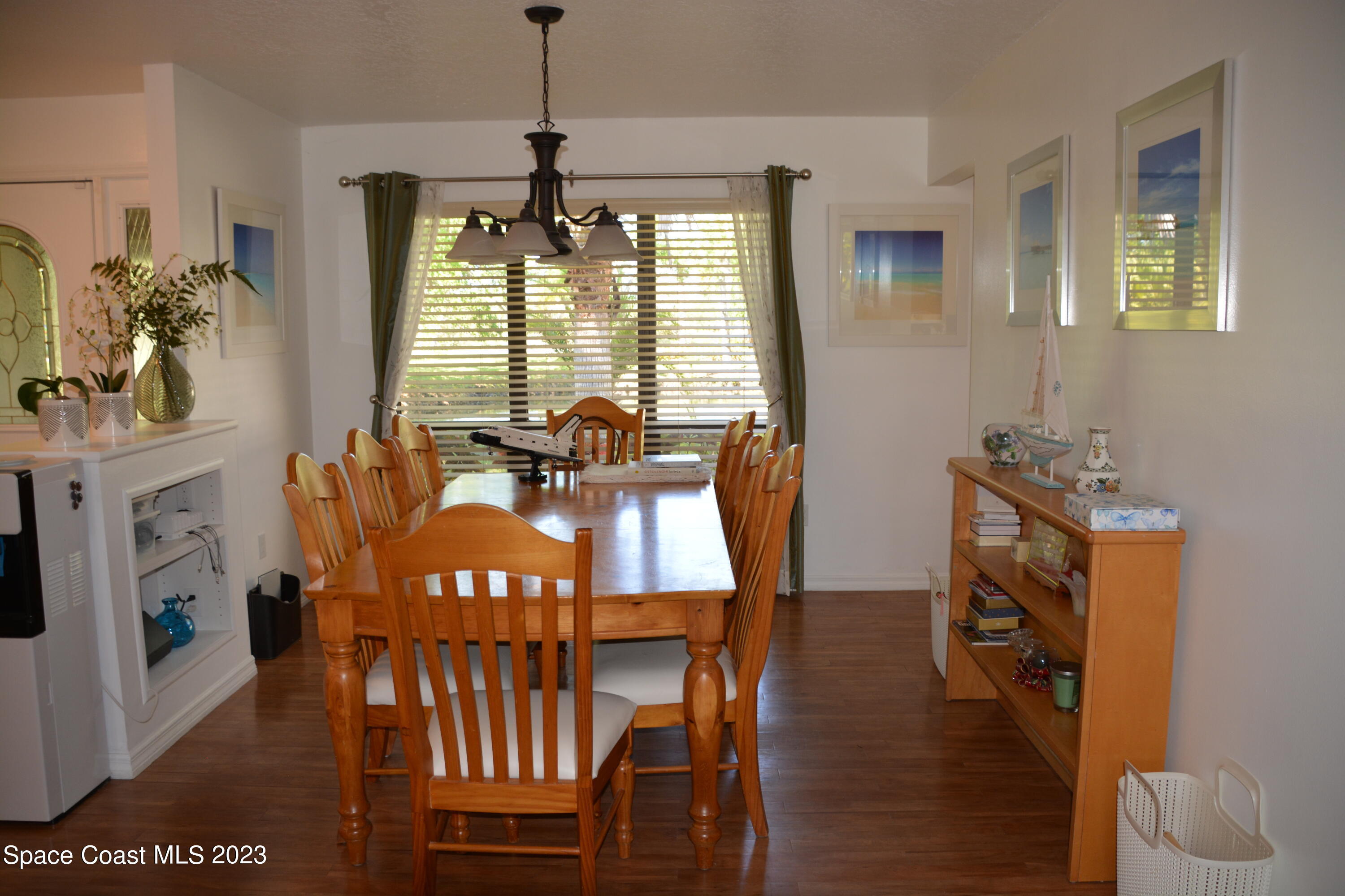 1045 Pine Island Road Merritt Island, FL 32953 - Photo 5 of 42 a view of a dining room with furniture window and wooden floor