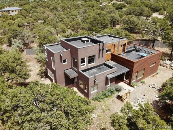 an aerial view of a house with a yard