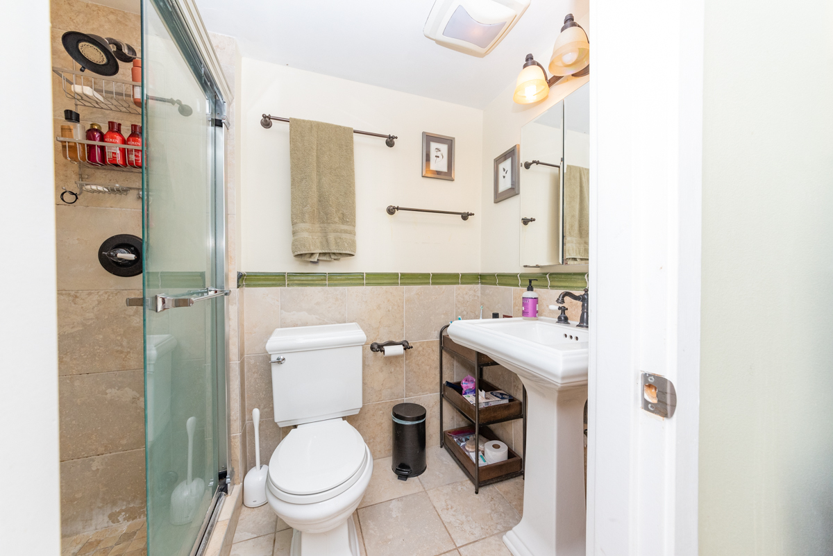 Undisclosed Address Chicago, IL 60614 - Photo 12 of 22 a bathroom with a sink toilet and shower