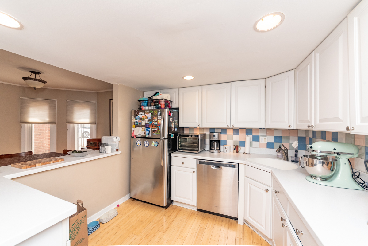 Undisclosed Address Chicago, IL 60614 - Photo 3 of 22 a kitchen with a sink a refrigerator and cabinets