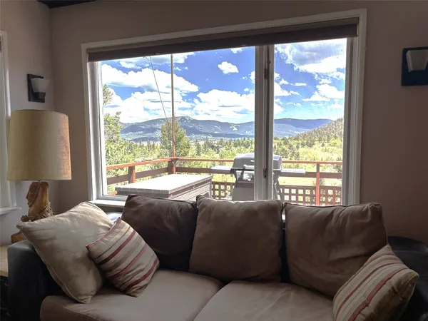a living room with a couch and a large window