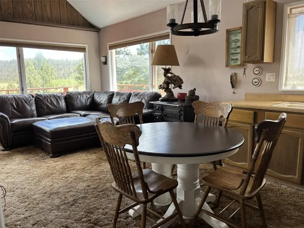 a living room with furniture a window and a chandelier