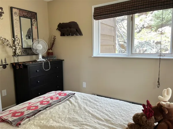 a bedroom with a bed and window