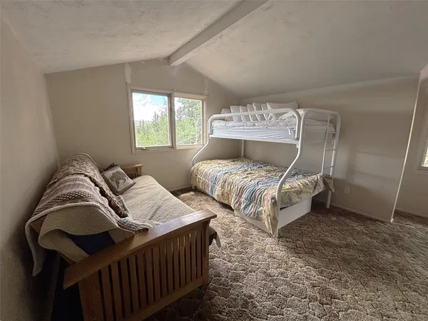 a bedroom with bed and a window