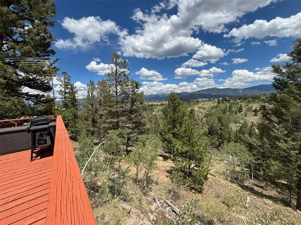 a balcony with next to a yard