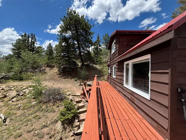 a view of balcony with wooden floor and fence