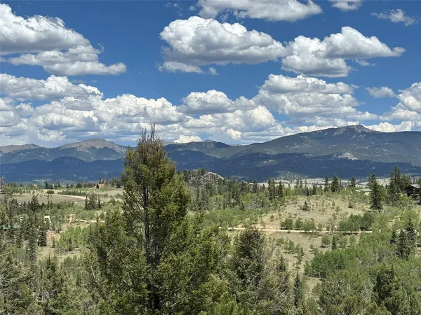 a balcony with wooden floor and outdoor seating