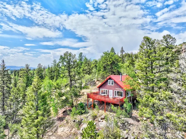 view of a house with a yard and a flower garden