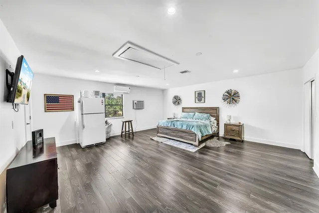 a bedroom with a bed and a view of kitchen