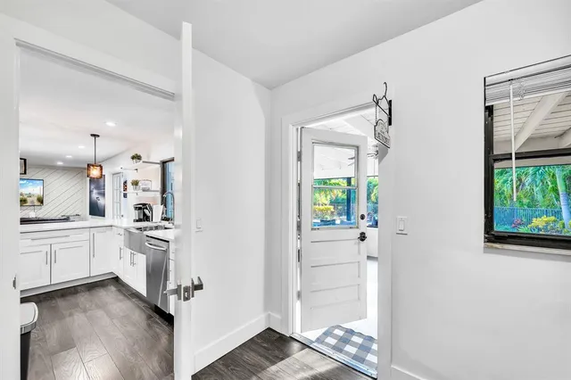 a living room with furniture and floor to ceiling windows