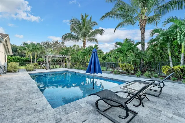 a view of a hallway with furniture and wooden floor