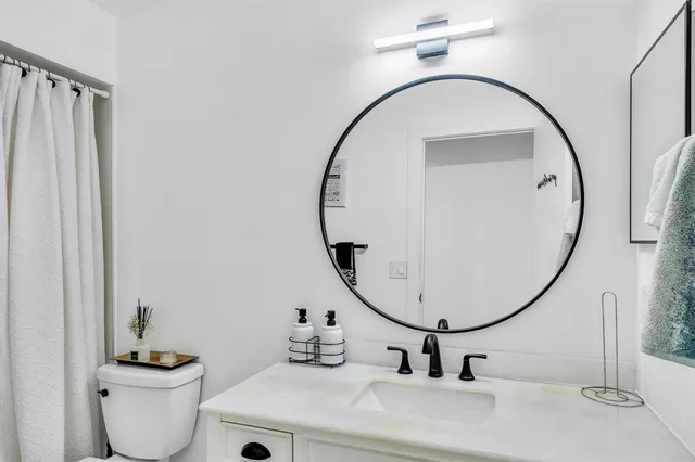 a bedroom with a bed and dresser