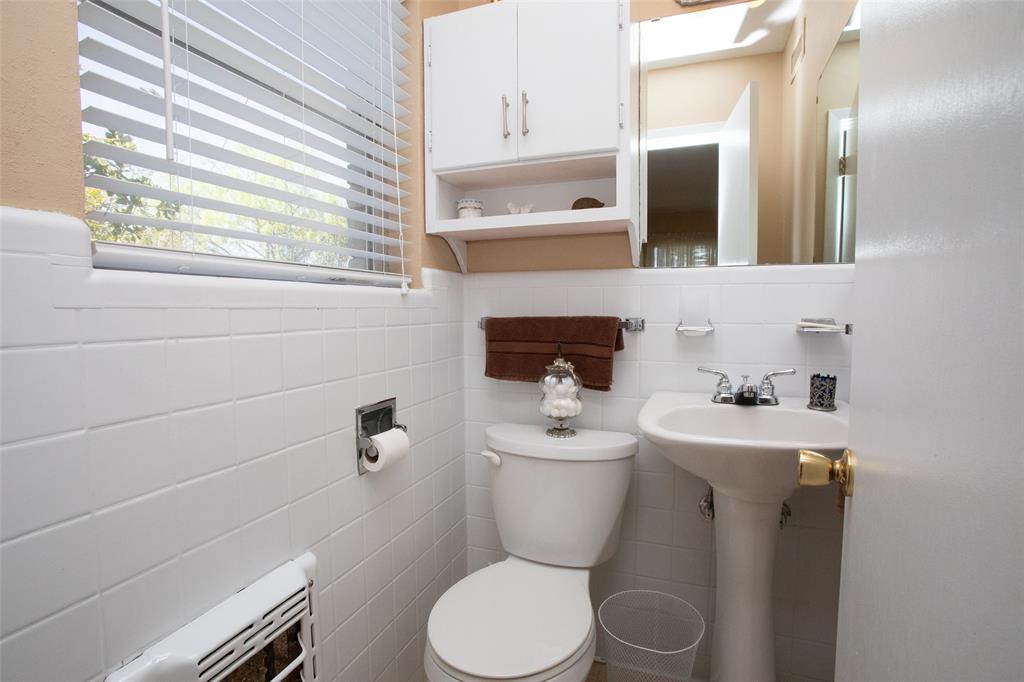 914 Fairview Street Graham, TX 76450 - Photo 11 of 17 a bathroom with a toilet sink and mirror