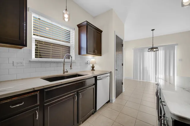 a kitchen that has a sink and a stove in it