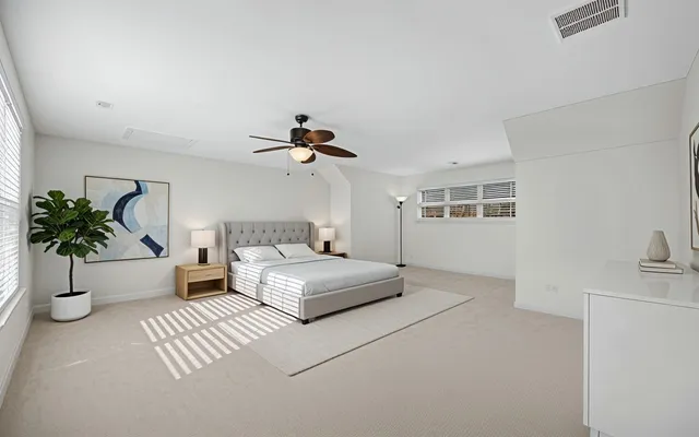 a spacious bedroom with a large bed and a couch