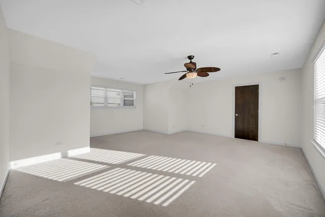 a view of a bedroom with a bed and window