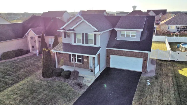 a view of a white house next to a yard