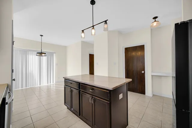 a kitchen with stainless steel appliances granite countertop a sink and a refrigerator