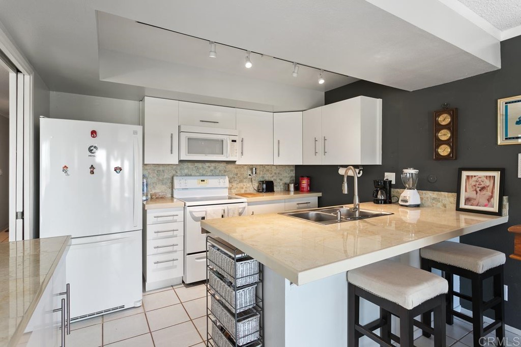 3606 Vista Rey Oceanside, CA 92057 - Photo 20 of 40 a kitchen with a refrigerator a stove a sink and a refrigerator