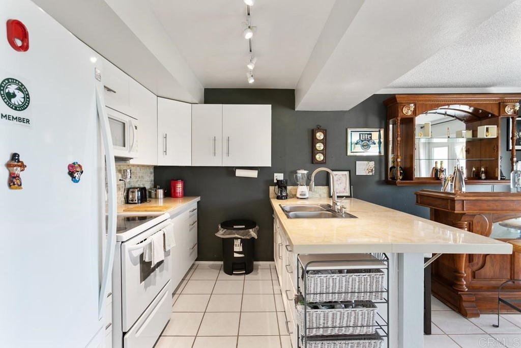 3606 Vista Rey Oceanside, CA 92057 - Photo 21 of 40 a kitchen with stainless steel appliances a stove a sink and a refrigerator