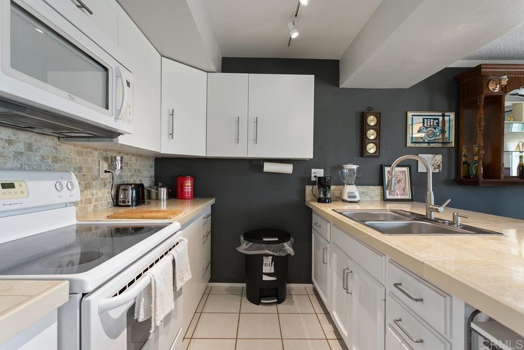 3606 Vista Rey Oceanside, CA 92057 - Photo 22 of 40 a kitchen with a sink dishwasher and cabinets