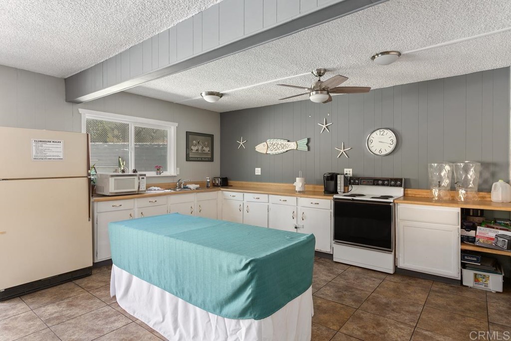 3606 Vista Rey Oceanside, CA 92057 - Photo 34 of 40 a kitchen with stainless steel appliances granite countertop a sink dishwasher stove top oven and cabinets