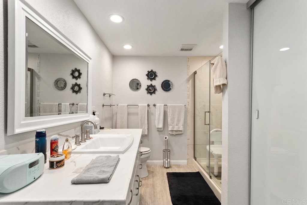 3606 Vista Rey Oceanside, CA 92057 - Photo 8 of 40 a bathroom with a double vanity sink mirror and shower