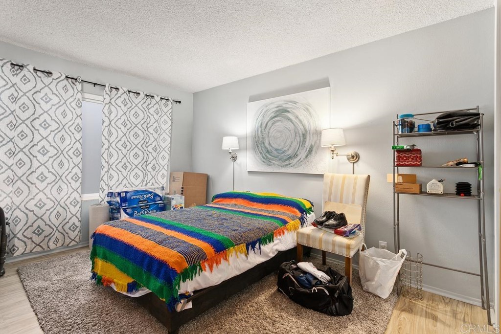 3606 Vista Rey Oceanside, CA 92057 - Photo 10 of 40 a bedroom with bed and a chandelier