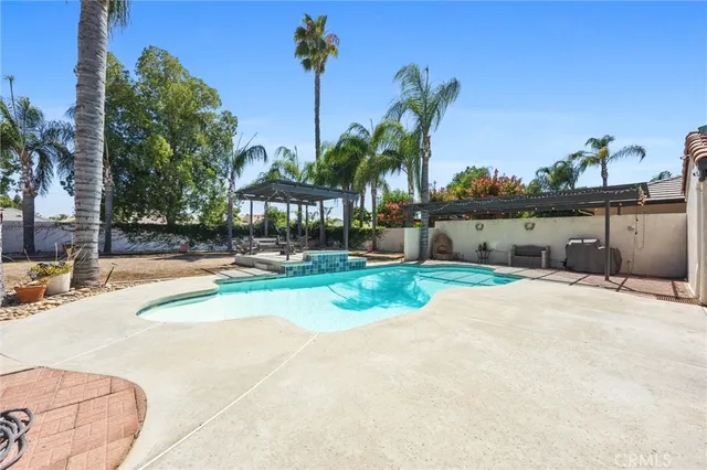 a view of a swimming pool and a yard