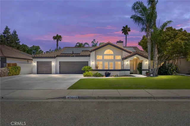 a front view of a house with a garden and a yard