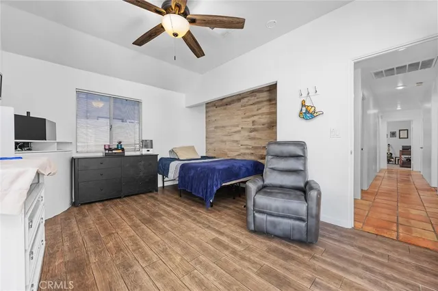 a bedroom with a bed and wooden floor