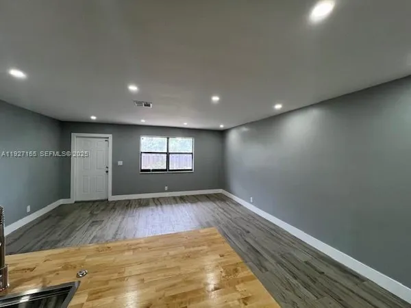 a kitchen with stainless steel appliances granite countertop a sink and a stove