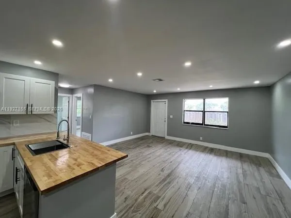 a view of a kitchen cabinets and a wooden floor