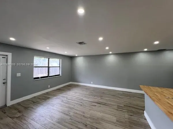 a kitchen with stainless steel appliances granite countertop a sink and a microwave