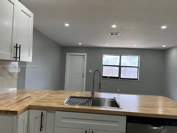 a bathroom with a sink and a window