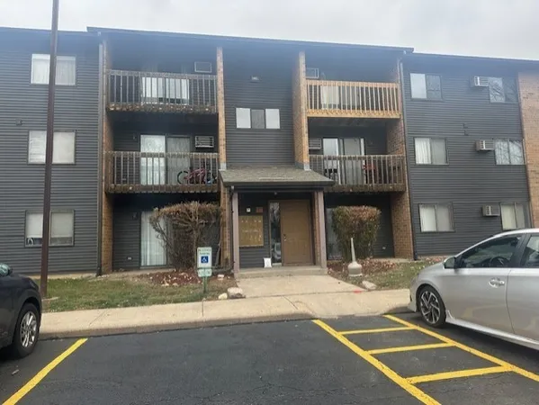 a view of a building with car parked