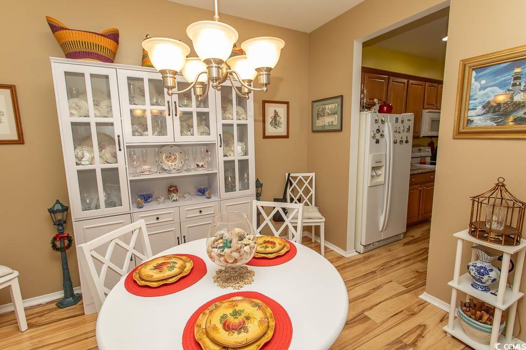 328 Kiskadee Loop, Unit E Conway, SC 29526 - Photo 11 of 37 Dining area with a chandelier and light wood-type flooring