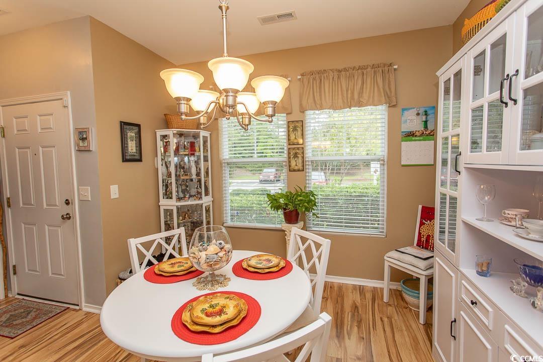 328 Kiskadee Loop, Unit E Conway, SC 29526 - Photo 13 of 37 Dining room with light wood finished floors and a chandelier