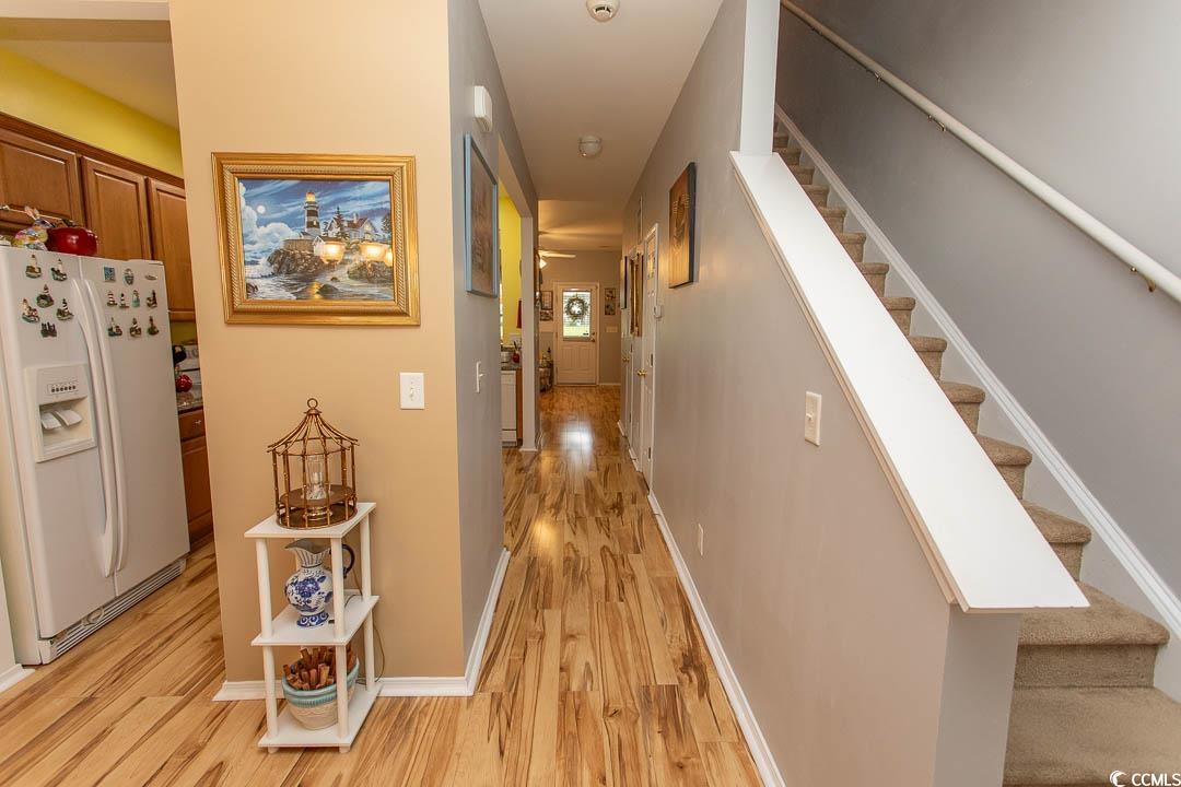 328 Kiskadee Loop, Unit E Conway, SC 29526 - Photo 14 of 37 Hallway with light wood-type flooring and stairs