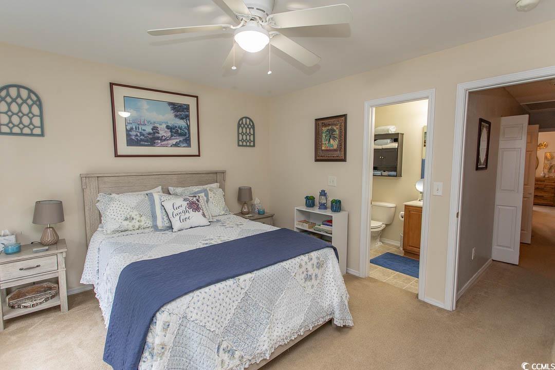 328 Kiskadee Loop, Unit E Conway, SC 29526 - Photo 18 of 37 Bedroom featuring light carpet, ceiling fan, and ensuite bathroom