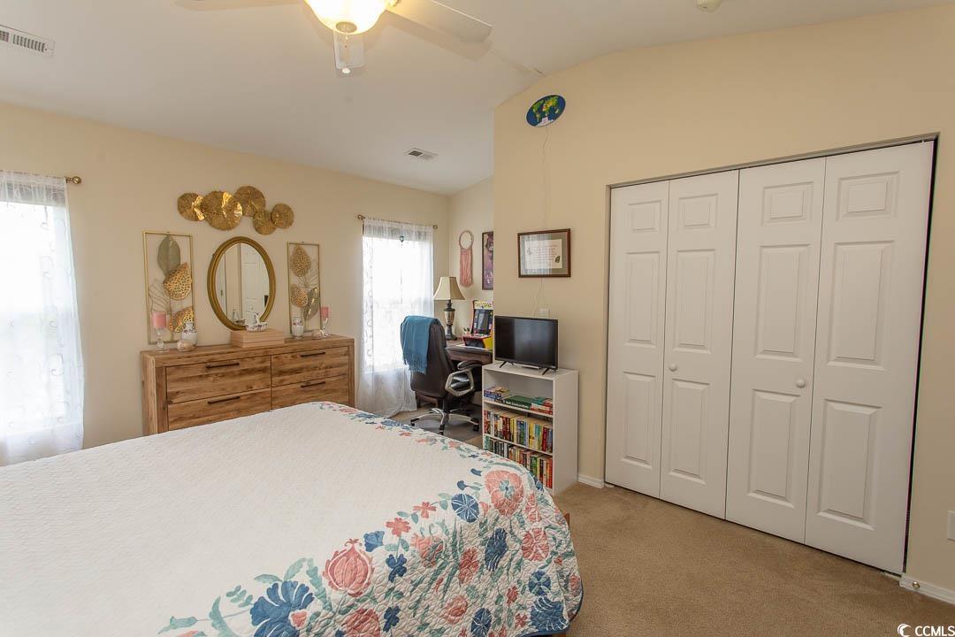 328 Kiskadee Loop, Unit E Conway, SC 29526 - Photo 22 of 37 Bedroom featuring light colored carpet, a ceiling fan, a closet, and vaulted ceiling
