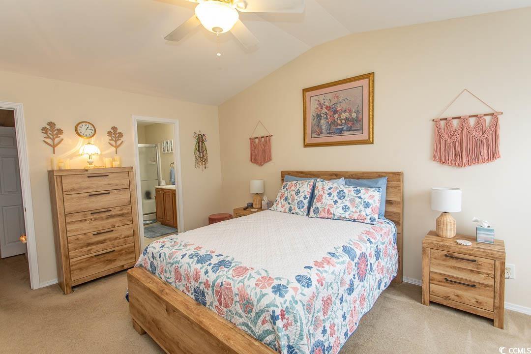 328 Kiskadee Loop, Unit E Conway, SC 29526 - Photo 25 of 37 Bedroom with vaulted ceiling, light colored carpet, a ceiling fan, and connected bathroom