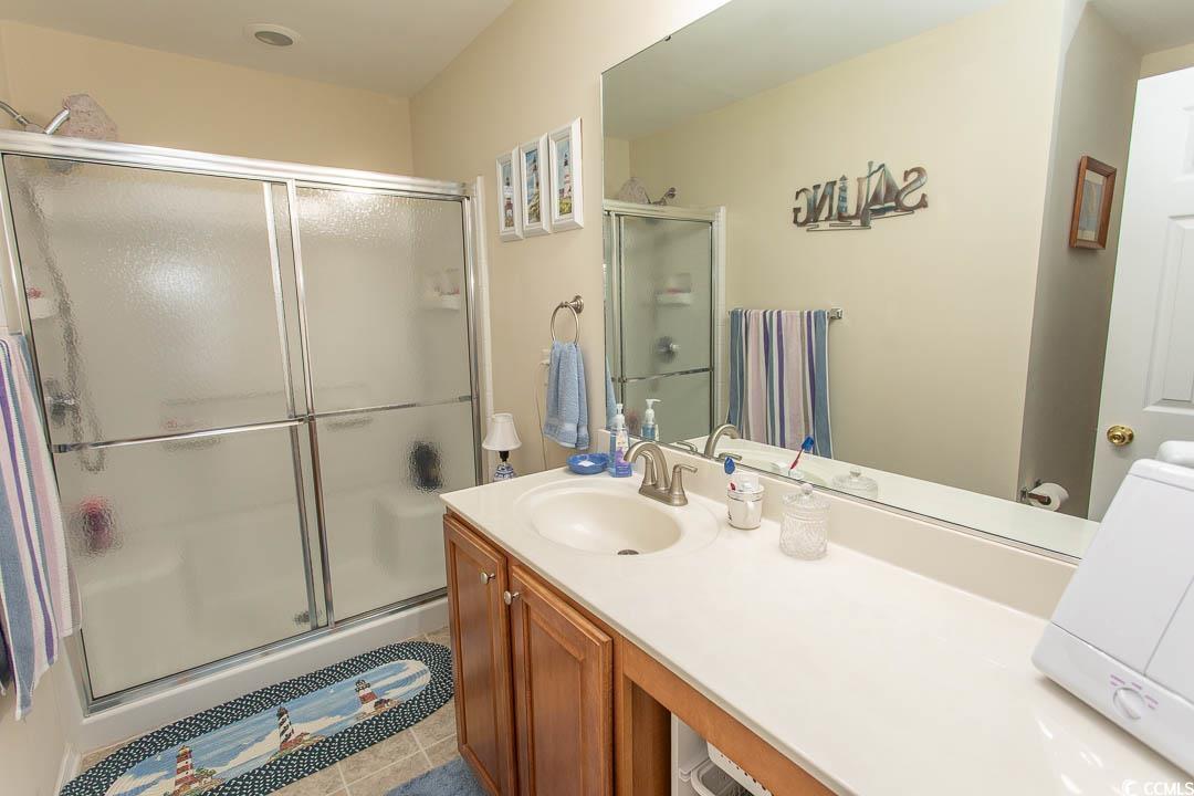 328 Kiskadee Loop, Unit E Conway, SC 29526 - Photo 26 of 37 Bathroom featuring vanity, a shower stall, and light tile patterned floors