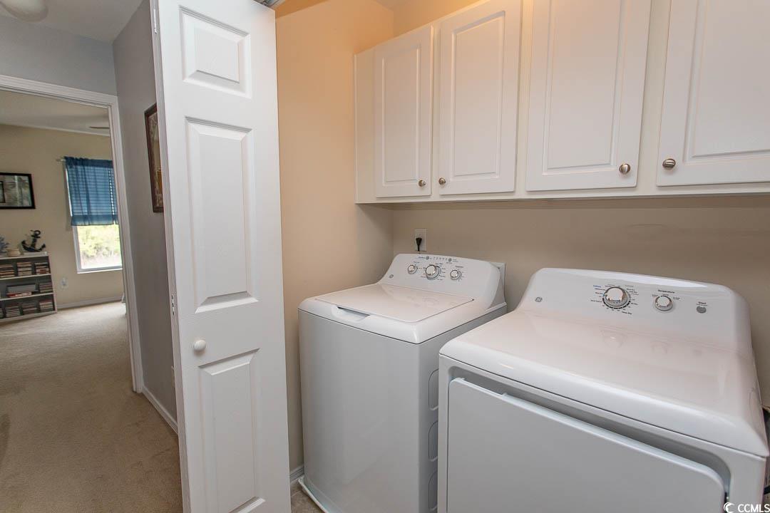 328 Kiskadee Loop, Unit E Conway, SC 29526 - Photo 28 of 37 Laundry area with light carpet, washing machine and clothes dryer, and cabinet space