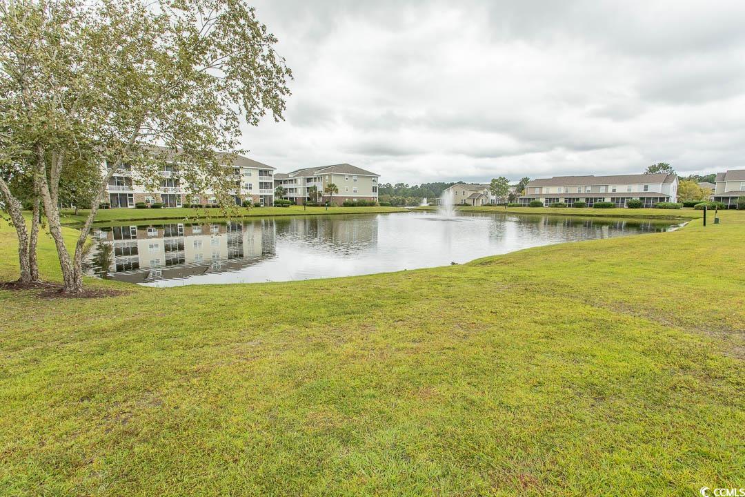 328 Kiskadee Loop, Unit E Conway, SC 29526 - Photo 33 of 37 Back of property featuring a lawn and a sunroom