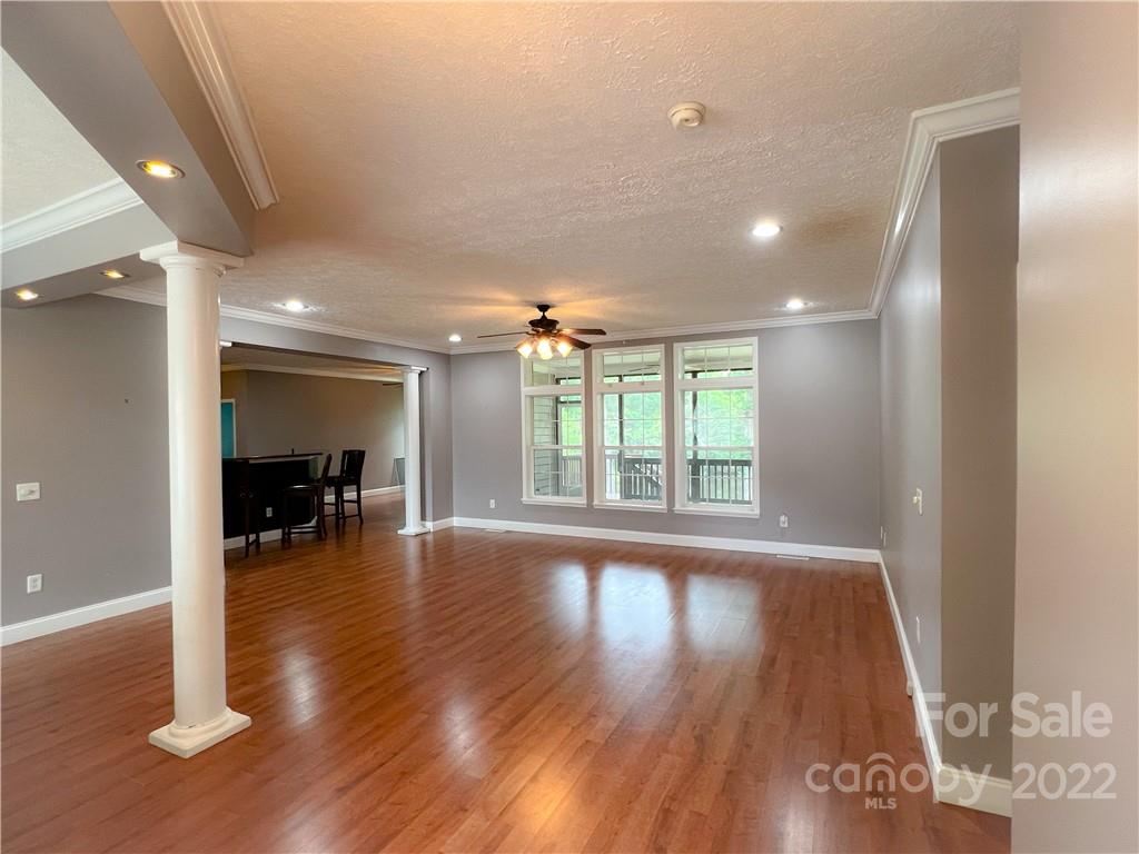 2223 Rodman Road Chester, SC 29706 - Photo 5 of 35 an empty room with wooden floor and a floor to ceiling window